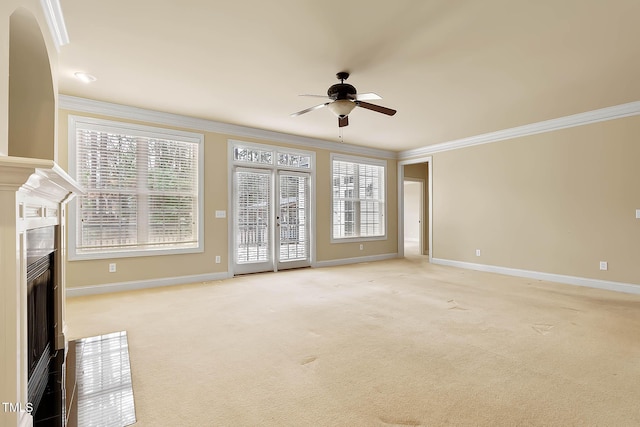 unfurnished living room featuring light carpet, crown molding, and a wealth of natural light