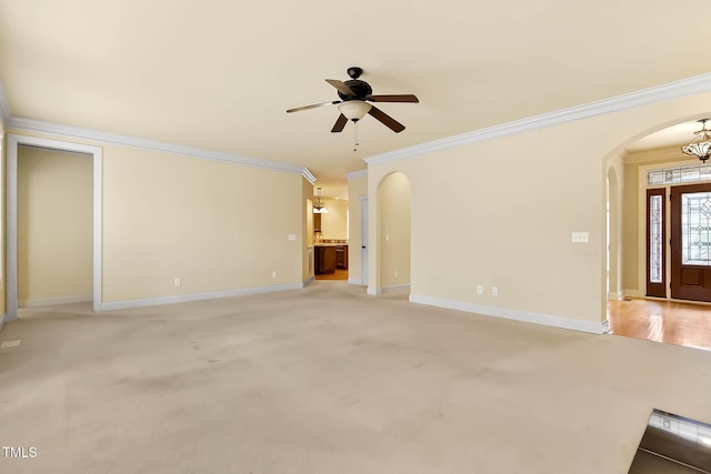 unfurnished living room featuring light carpet, ornamental molding, and ceiling fan