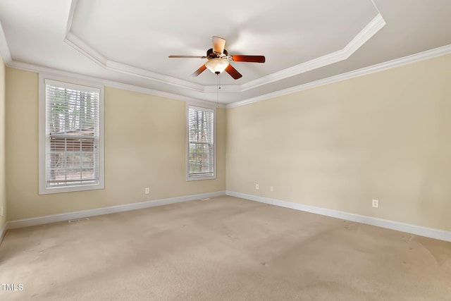 unfurnished room featuring ceiling fan, ornamental molding, a tray ceiling, and carpet floors