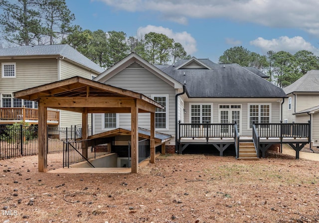 back of property featuring a wooden deck