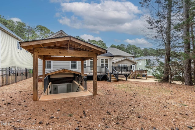 rear view of property with a wooden deck