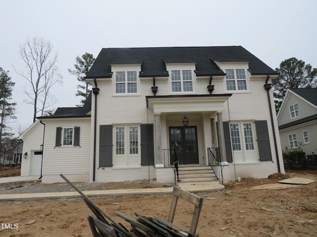 view of front facade featuring a garage and french doors