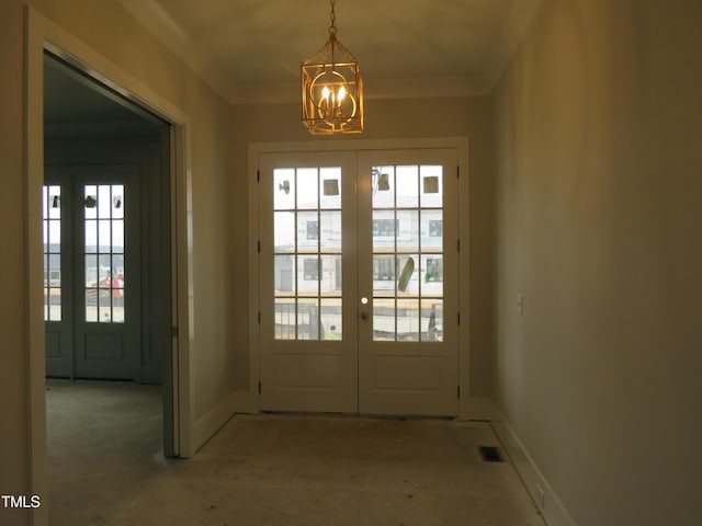 doorway featuring a notable chandelier, ornamental molding, and french doors