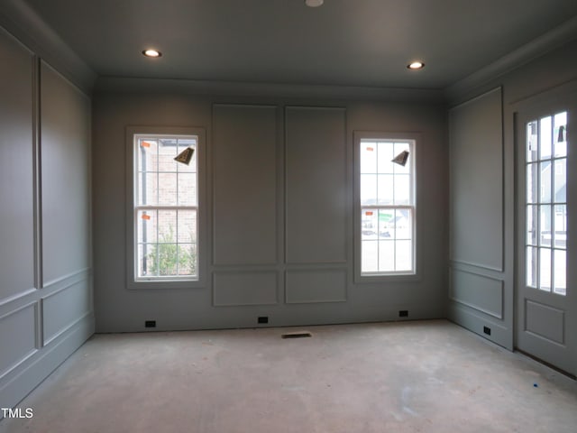 unfurnished room featuring visible vents, a decorative wall, and recessed lighting