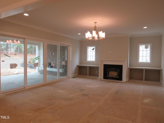 unfurnished living room with recessed lighting, a fireplace, crown molding, and an inviting chandelier