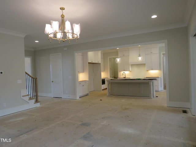 unfurnished living room featuring sink, crown molding, and a notable chandelier