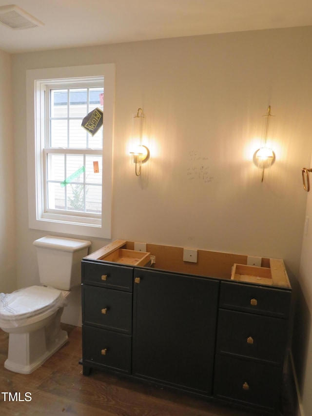 bathroom featuring toilet and visible vents