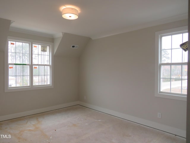 additional living space with baseboards and visible vents