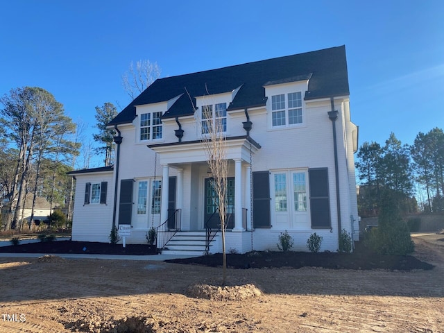 view of front facade featuring french doors and brick siding