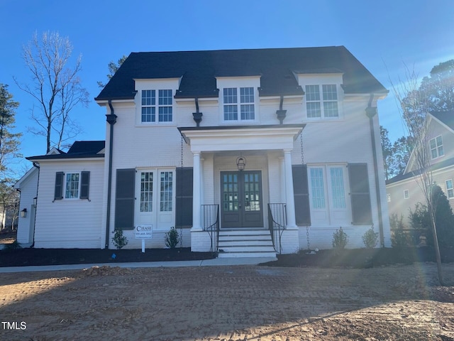 view of front of property featuring brick siding and french doors