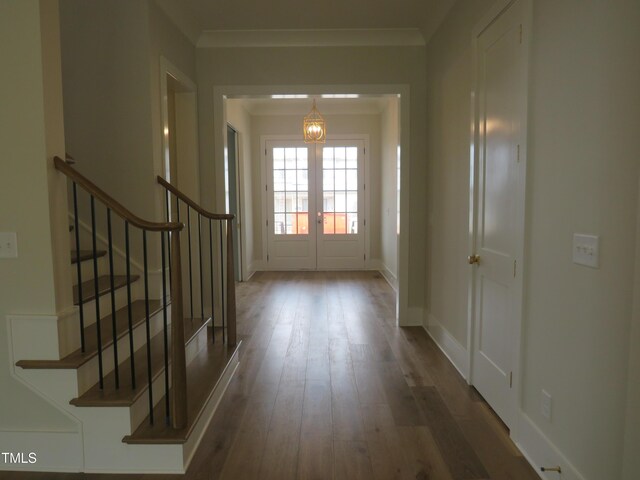interior space featuring ornamental molding, french doors, stairs, and wood finished floors
