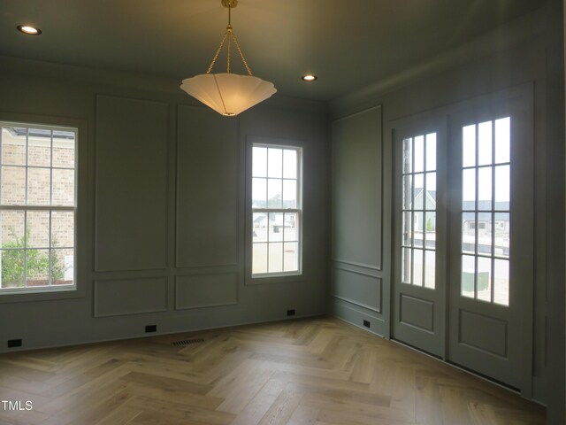 unfurnished dining area with recessed lighting, visible vents, and a decorative wall
