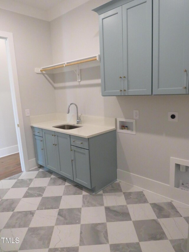 laundry area featuring a sink, cabinet space, baseboards, hookup for an electric dryer, and hookup for a washing machine