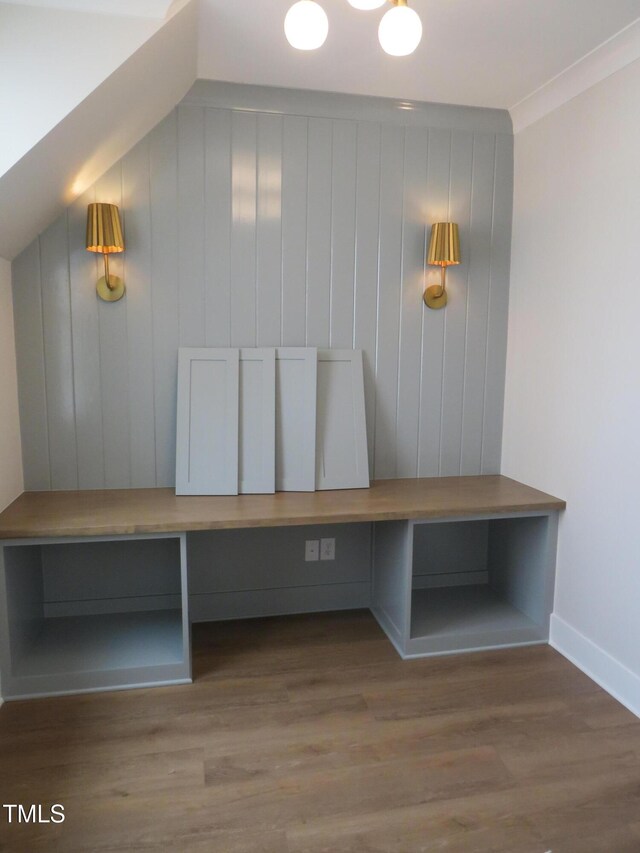 mudroom featuring ornamental molding, baseboards, and wood finished floors