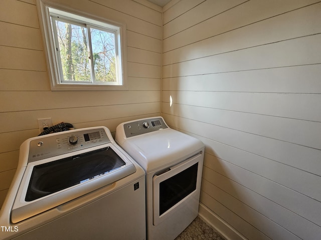 clothes washing area with washer and clothes dryer