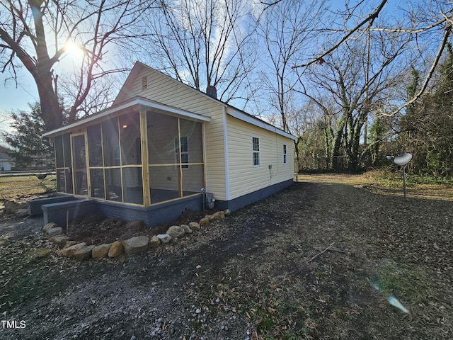 view of home's exterior featuring a sunroom