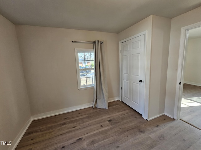 unfurnished bedroom with hardwood / wood-style flooring