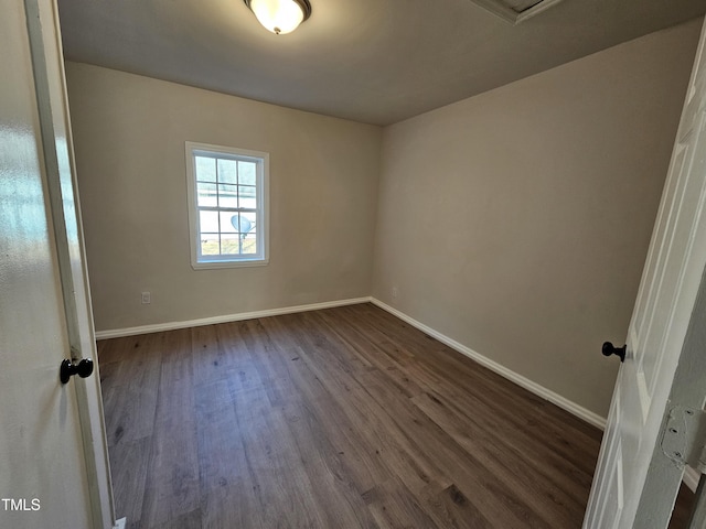 spare room with dark wood-type flooring