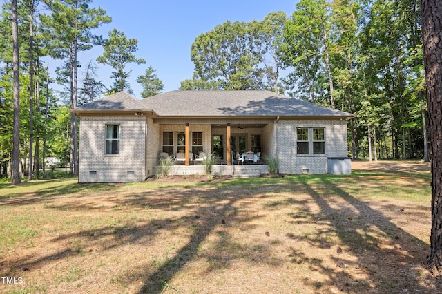 back of property featuring a yard and ceiling fan