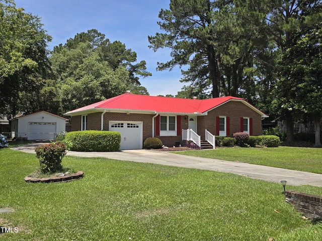 ranch-style home featuring an outbuilding, a garage, and a front yard