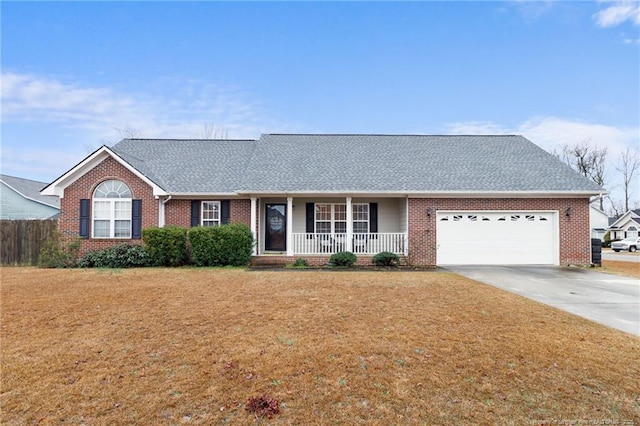 single story home with a porch, a garage, and a front yard