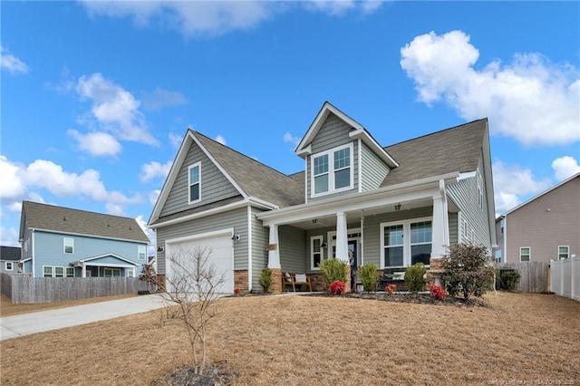 view of front facade featuring a garage, a front yard, and a porch