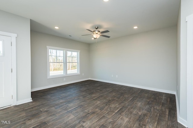 empty room featuring dark wood-type flooring and ceiling fan