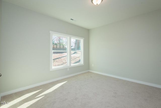 spare room with light colored carpet