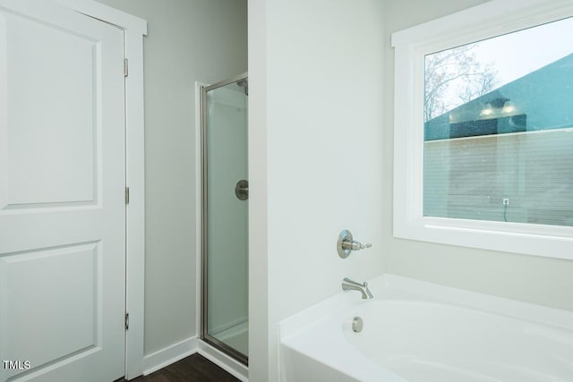 bathroom with shower with separate bathtub