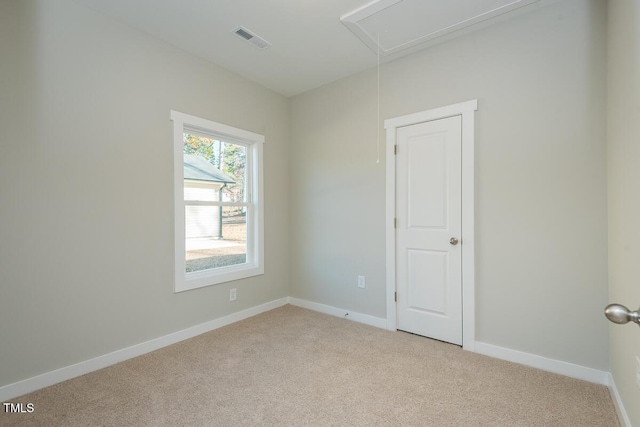 empty room featuring light colored carpet