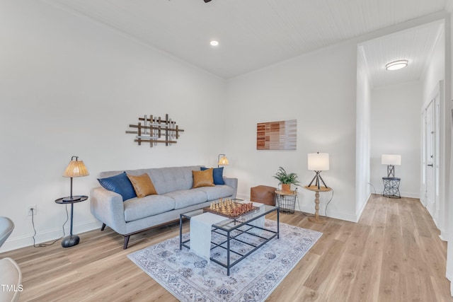 living room featuring ornamental molding and light wood-type flooring