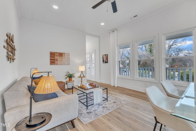 living room with ceiling fan, light hardwood / wood-style flooring, and a healthy amount of sunlight