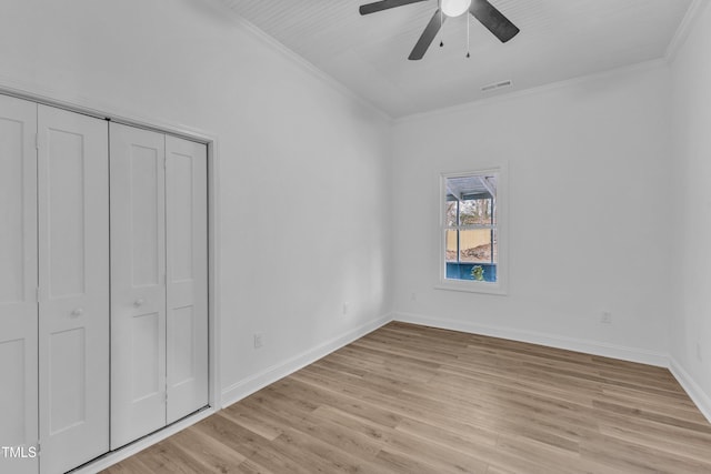 unfurnished bedroom featuring ornamental molding, a closet, ceiling fan, and light hardwood / wood-style flooring