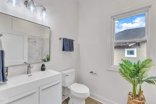 bathroom with vanity, toilet, and a shower