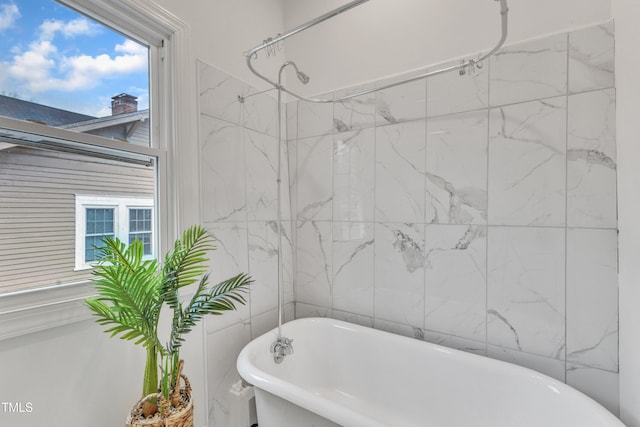 bathroom featuring shower with separate bathtub