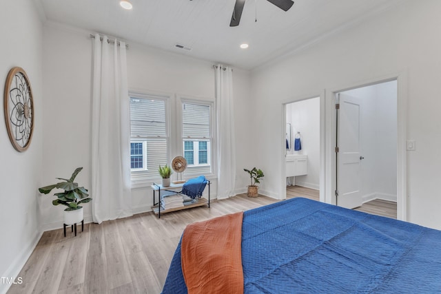 bedroom with ceiling fan, connected bathroom, and light wood-type flooring