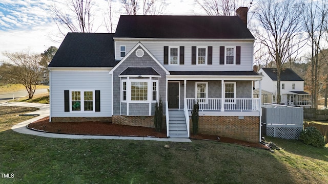 view of front of property featuring a front yard and covered porch