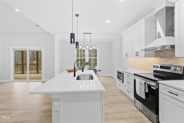 kitchen with sink, white cabinets, a kitchen island with sink, electric range, and wall chimney exhaust hood