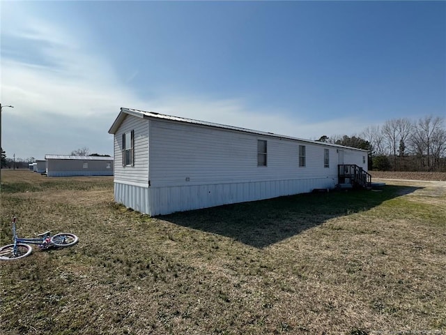 view of home's exterior with a yard