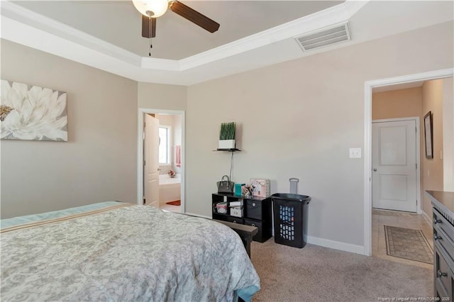 bedroom featuring ensuite bathroom, crown molding, light carpet, a raised ceiling, and ceiling fan