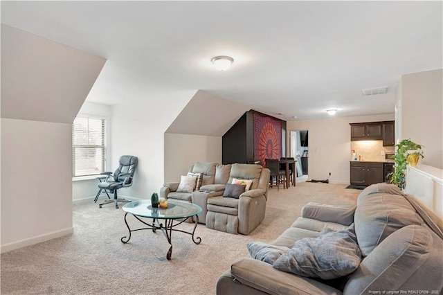 carpeted living room with vaulted ceiling