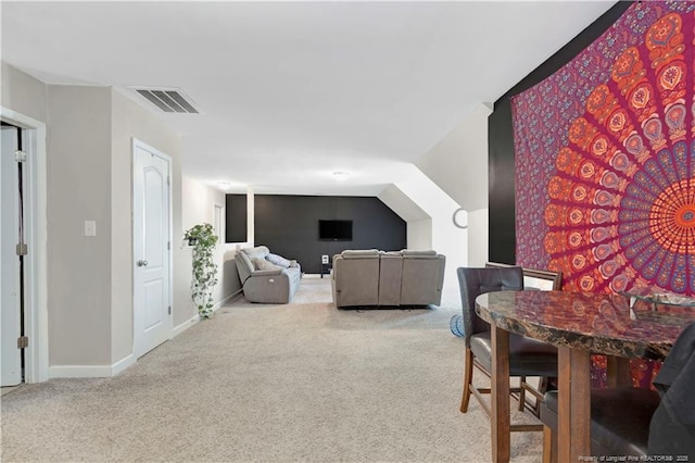 carpeted living room featuring lofted ceiling