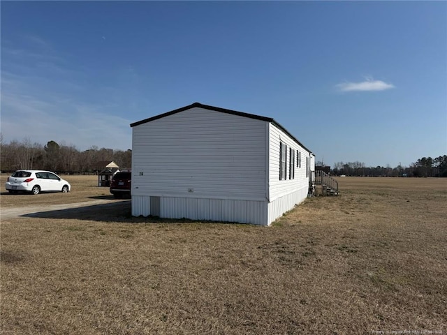 view of property exterior with a yard