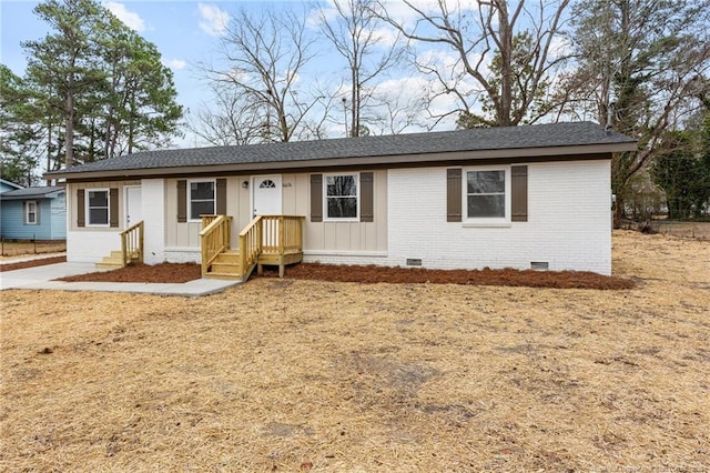 single story home with crawl space, board and batten siding, brick siding, and roof with shingles