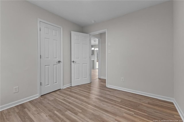 unfurnished bedroom with light wood-style floors and baseboards