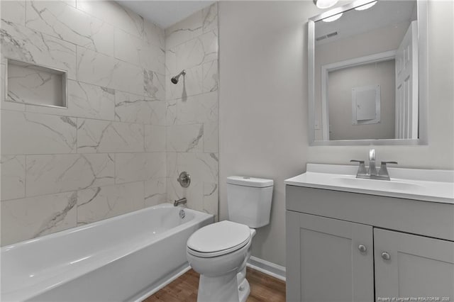 bathroom with visible vents, toilet, wood finished floors, bathtub / shower combination, and vanity