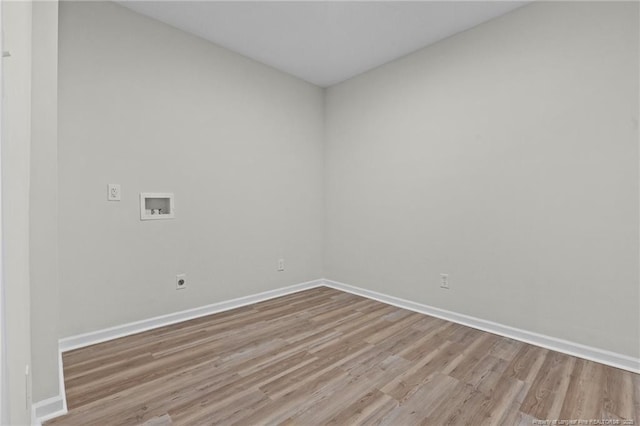 spare room featuring wood finished floors and baseboards