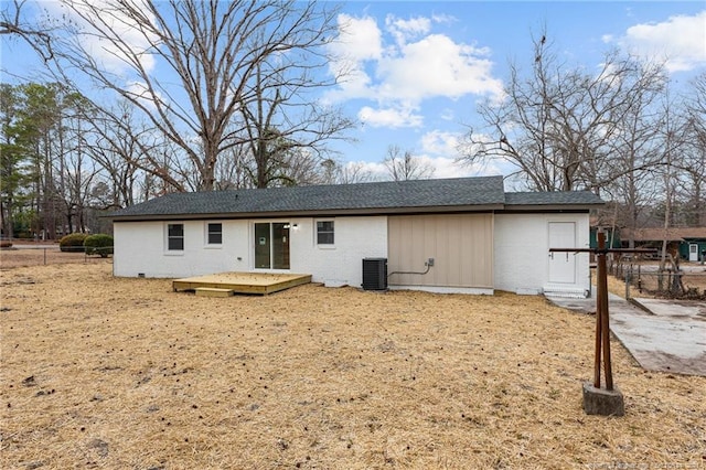 back of property featuring brick siding, central air condition unit, a deck, and fence