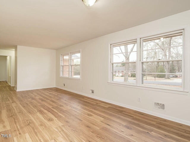 spare room with light hardwood / wood-style floors