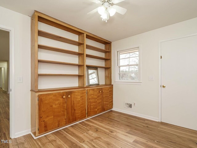 interior space with ceiling fan and light hardwood / wood-style floors